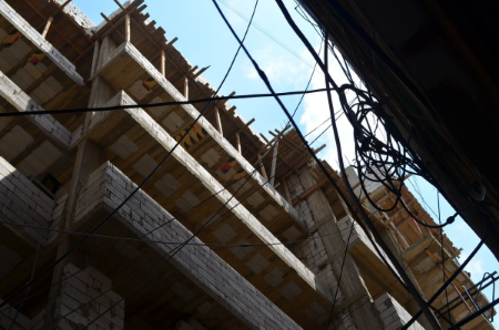 For Shatilans, the skyward expansion signifies both moral and material disorder